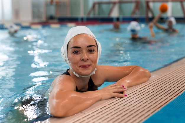 Free photo water polo player at the pool with swimming equipment