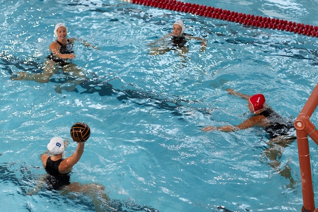 Free photo water polo players at the pool with swimming equipment