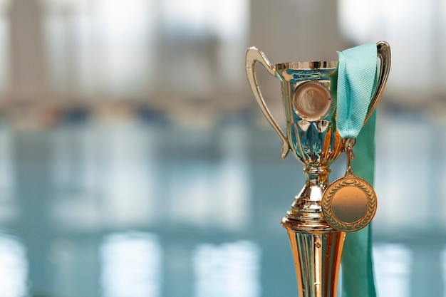 Free photo water polo trophy by the pool