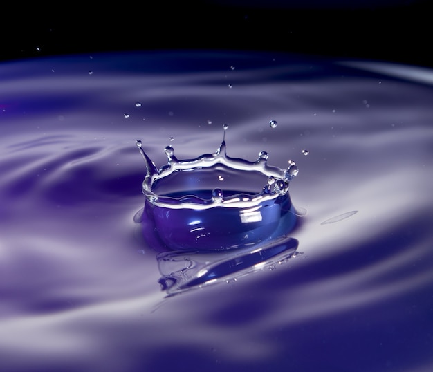 Water splash in purple tone with black background