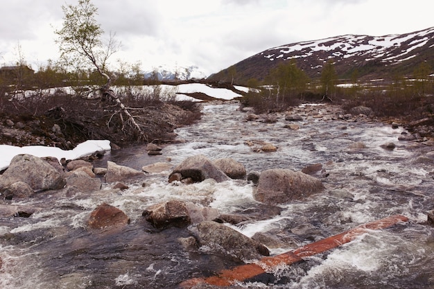 Water splashes against the rocks on the river 