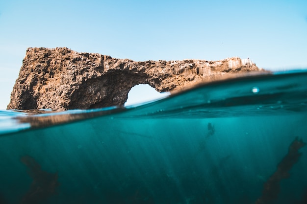 Free Photo water surface level shot of rocks and reefs at the sea on a sunny day