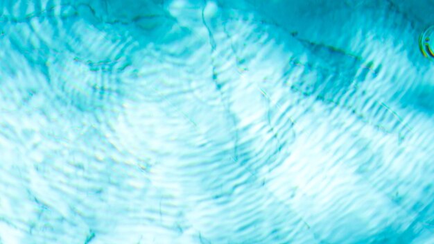 Water swimming pool texture and surface water on pool reflection blue wave nature water on the outdo...