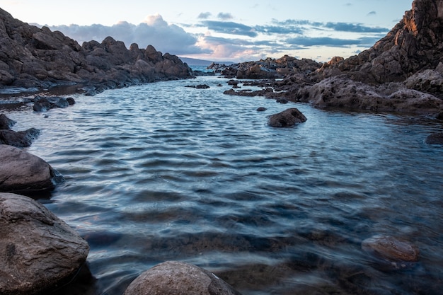 Water with stones in it sorounded with rocks