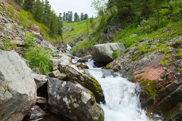 Free Photo waterfall in rocky  mountains