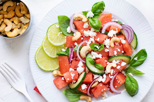 Free photo watermelon salad with cashew nuts and feta