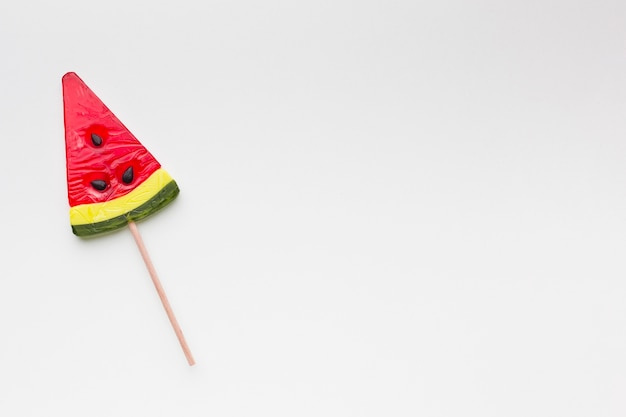 Watermelon shape lollipop on white table with copy space