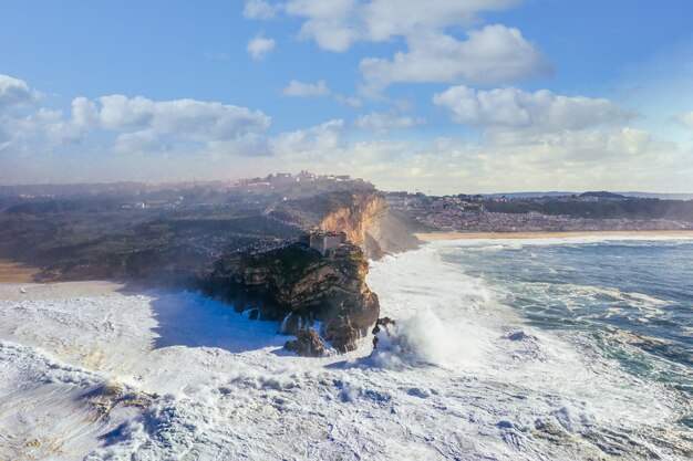 waves breaking at cliff