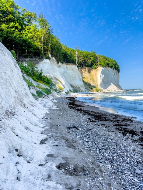 Free photo waves in sea near coastline on empty pebble beach