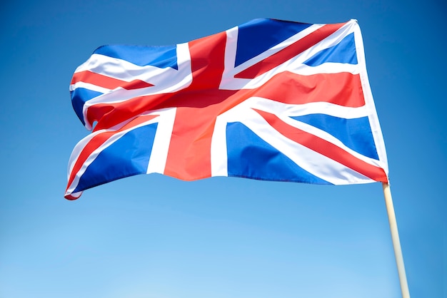 Free photo waving british flag in the sky