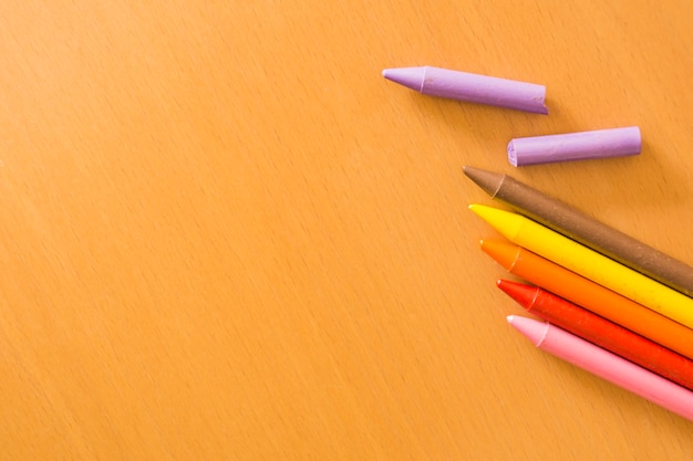 Wax crayons on wooden surface