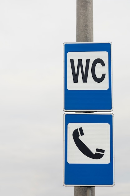 Wc and phone sign in the city