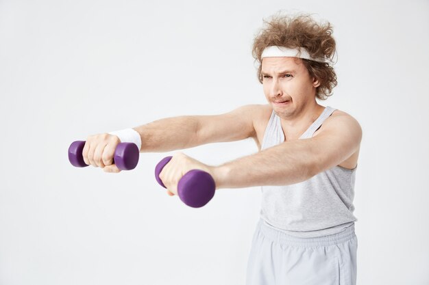 Weak retro man in old-fashioned sports wear training hard