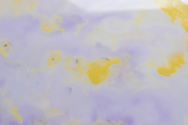 Free photo weathered painted wall with purple and yellow color stains