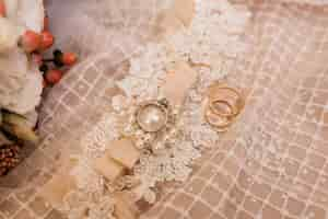 Free photo wedding accessories for a bride and wedding rings on the wedding dress