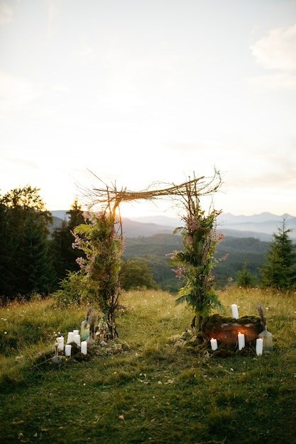 Free photo wedding altar made of green branches and wooden sticks