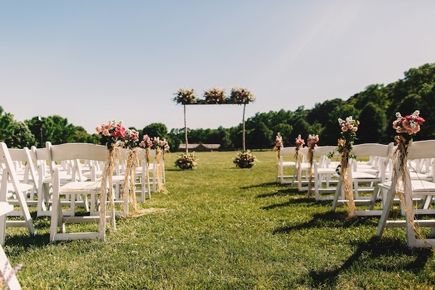 Wedding altar made of wooden sticks and bouquets stands