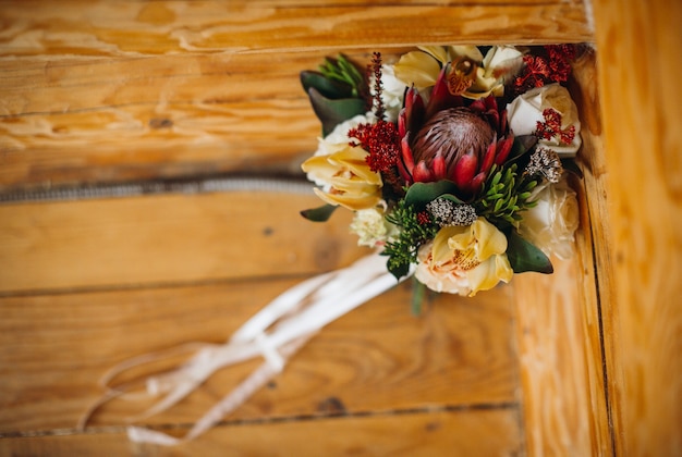 Free Photo wedding bouquet made of autumn flowers stands on the bench 