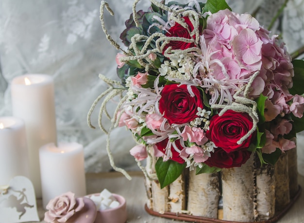 Free photo wedding bouquet in a wooden piece with white candles