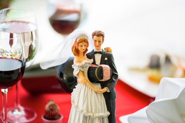 Wedding dolls holding a bottle