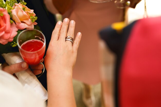 Wedding and engagement ring on delicate bride's hand 