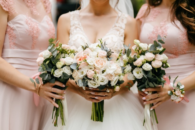 Wedding flowers, bride and bridesmaids holding their bouquets at wedding day