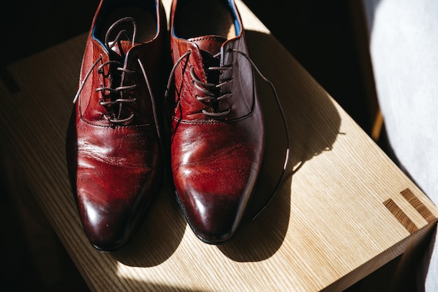 Free photo wedding groom shoes stand on a stool