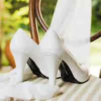 Free photo wedding high heels with scarf on table