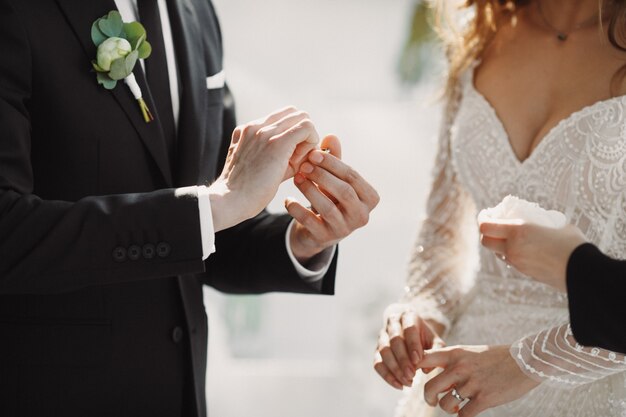 The wedding moment with the putting rings on the fingers