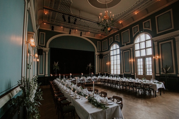 Wedding reception hall with an elegant table setting with candles