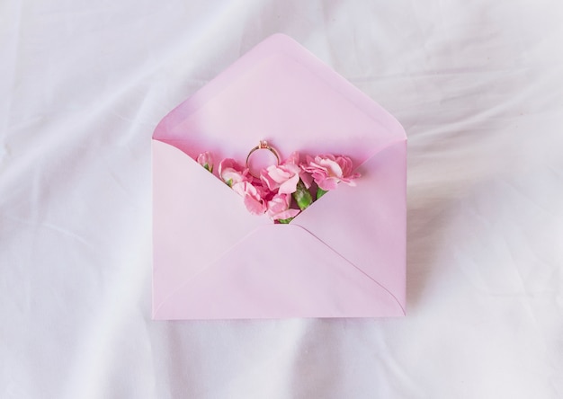 Wedding ring in envelope with flowers 