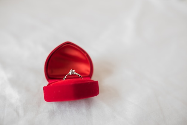 Wedding rings in a box on the bed