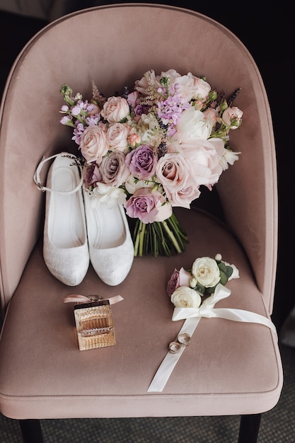 Free Photo wedding shoes, wedding bouquet made of dim pink and purple flowers on the chair