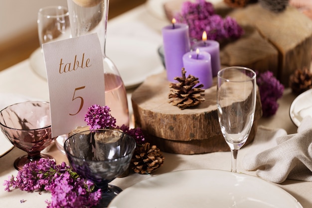 Wedding table with lit candles and flowers high angle