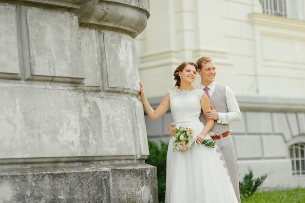 Free Photo wedding. wedding day. wedding couple. beautiful couple, against a white castle