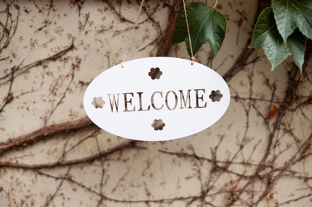 Free photo welcome sign with plant outdoors