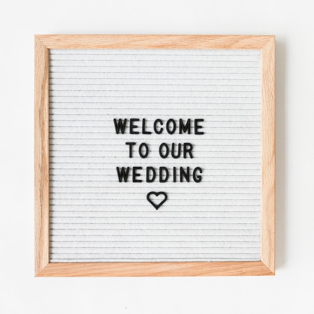 Free photo welcome text for wedding on wooden frame against white backdrop