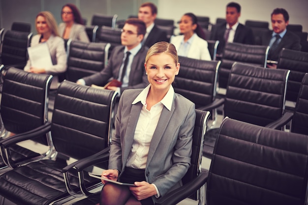 Free photo well-dressed businesswoman at a conference