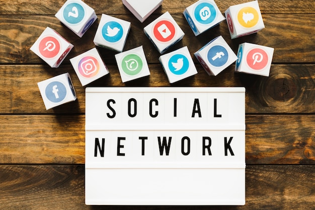 Free Photo well-known networking icons near social network text over wooden table