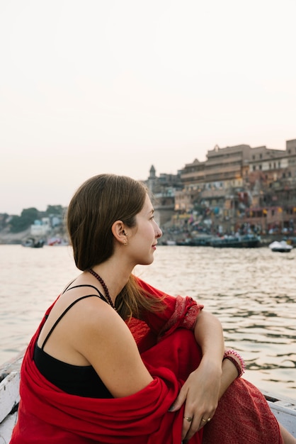 Western woman on a boat exploring the River Ganges