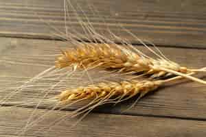 Free photo wheat ears on the wooden table