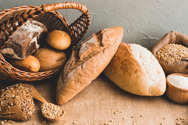 Free photo wheat loaves with buns in basket