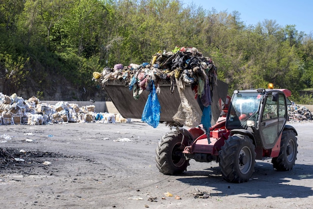 Wheel loader transporting municipal waste to the waste treatment plant