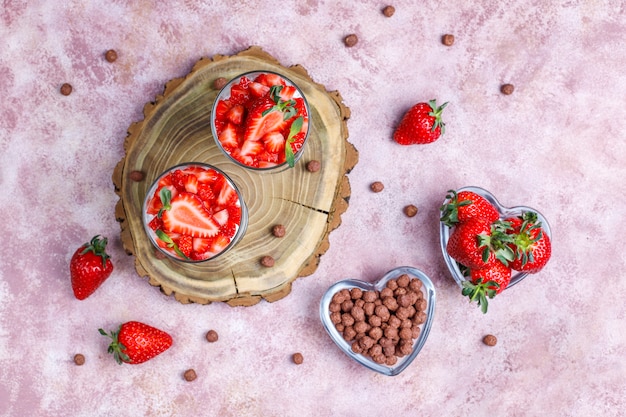 Whipped cream and strawberry trifle with honey and cereals.