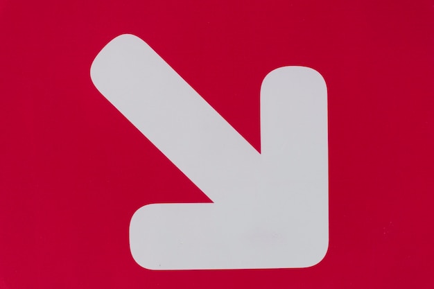 White arrow on red background