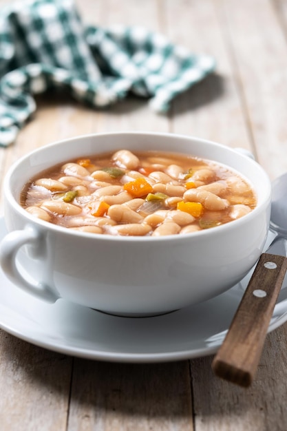 Free Photo white beans soup with vegetables in white bowl on wooden table