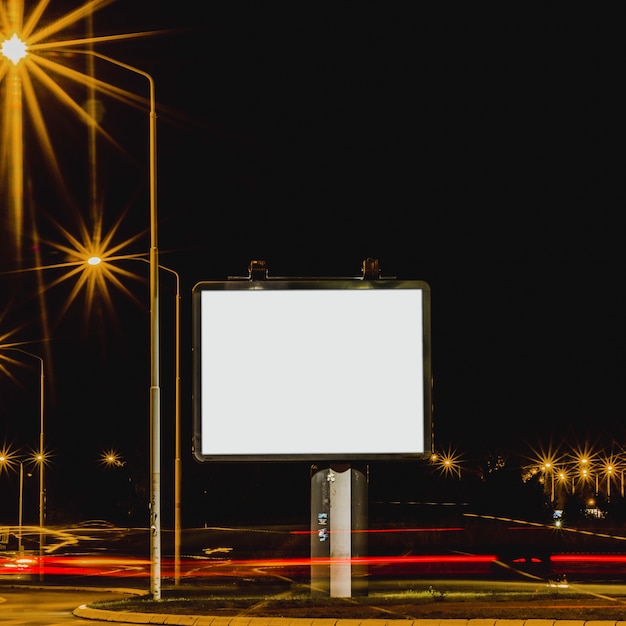 Free photo white billboard with traffic lights at night