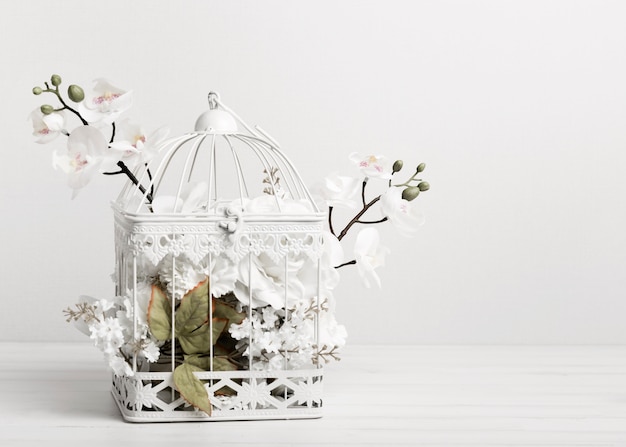 Free Photo white bird cage full of flowers