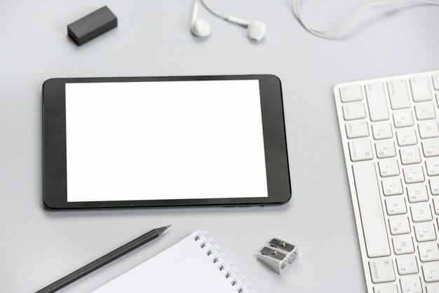 White blank digital tablet on gray office desk