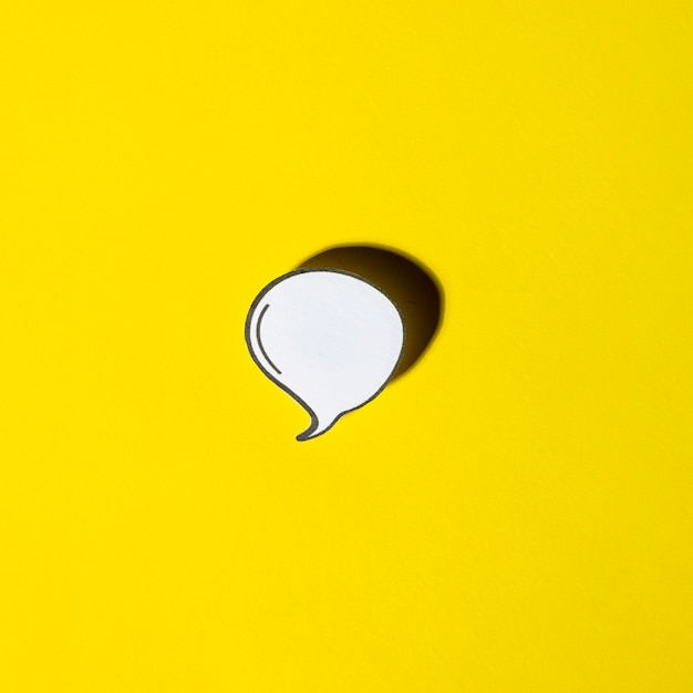 White blank speech bubble with shadow on yellow background